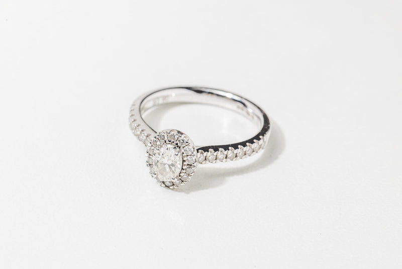 Oval diamond ring with diamond halo & diamond shank set in 18ct white gold.