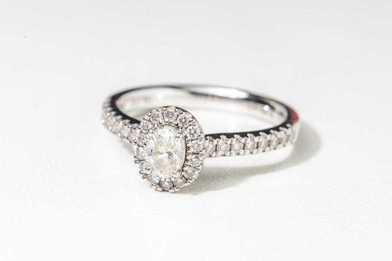 Oval diamond ring with diamond halo & diamond shank set in 18ct white gold.